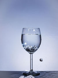 Close-up of drink in glass against blue background