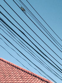 Low angle view of cables against sky