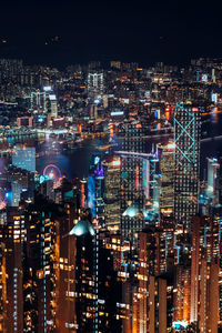 Aerial view of illuminated buildings in city at night