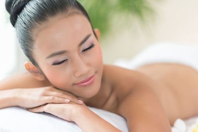 Woman sleeping on bed at spa