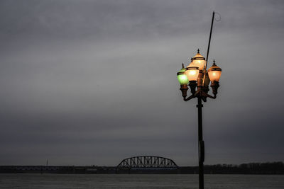 Low angle view of illuminated street light against sky