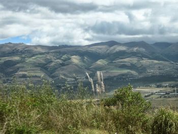 Scenic view of mountains against cloudy sky