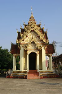 Facade of temple against building