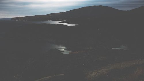 Scenic view of mountains against cloudy sky