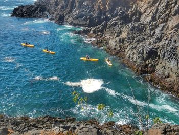 High angle view of people kayak in sea