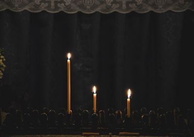 Illuminated candles in temple