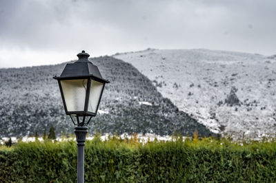 Close-up of illuminated light bulb against sky