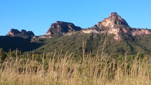 Scenic view of mountains against clear blue sky