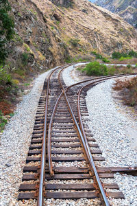 High angle view of railroad tracks by mountains