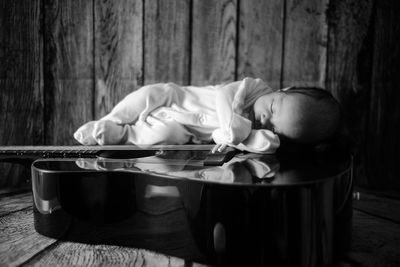 Baby sleeping on guitar