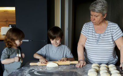 Children playing with vegetables in kitchen