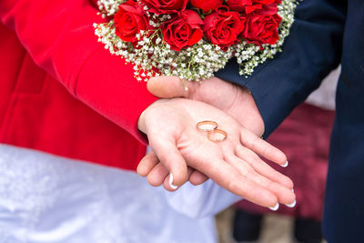 Close-up of bride holding wedding rings