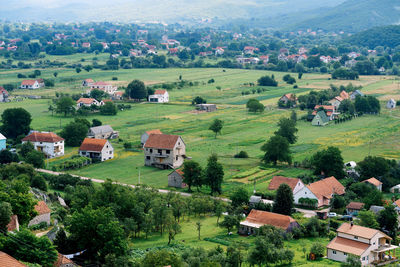 Scenic view of village and houses on field