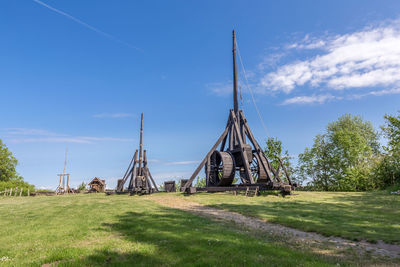 Traditional windmill on field against sky