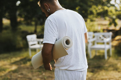 Man holding exercise mat