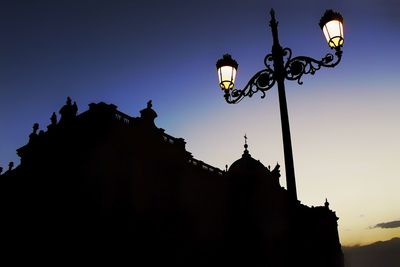 Low angle view of street light against sky at dusk