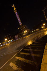 Illuminated city against sky at night