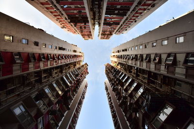 Low angle view of illuminated buildings in city against sky