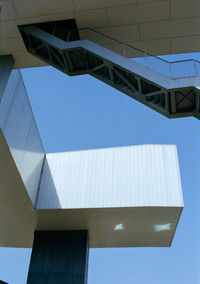 Low angle view of modern building against clear blue sky