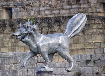 View of animal statue against brick wall