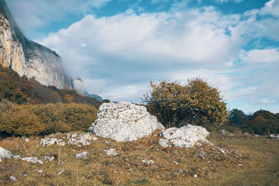 Rock formation on field against sky