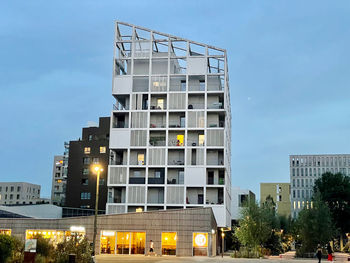 Low angle view of illuminated building against sky