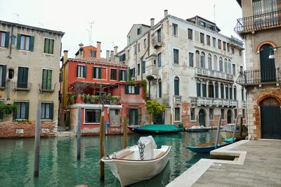 Boats in canal with buildings in background