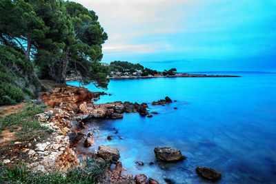 Scenic view of sea against blue sky