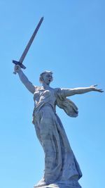 Low angle view of statue against clear blue sky