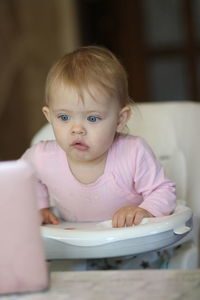 Portrait of cute baby girl sitting
