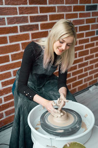 High angle view of woman making pottery