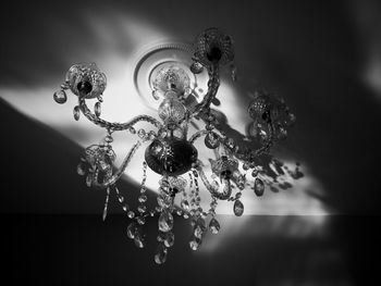 Low angle view of illuminated chandelier hanging from ceiling