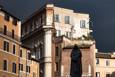 Statue of giordano bruno against buildings at campo de fiori