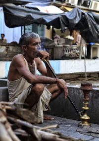 Man smoking hookah in village