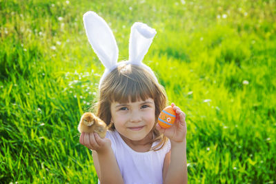 Portrait of girl playing in field