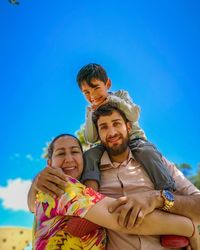 Portrait of smiling family against sky