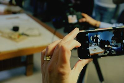 Cropped image of man holding mobile phone