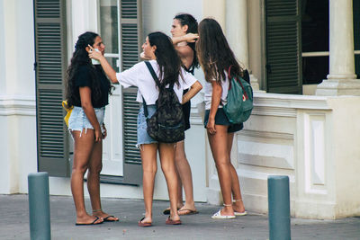 Group of people standing against built structure