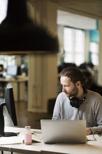 Businessman using computer at desk in creative office