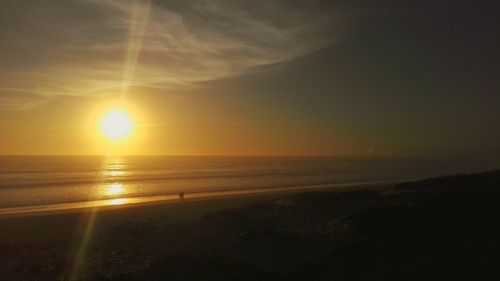 Scenic view of beach against sky during sunset