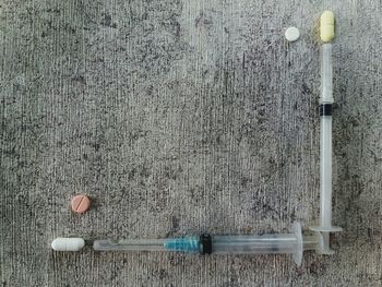 Directly above shot of pipes on table against wall