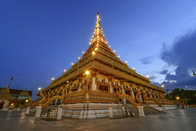 Low angle view of illuminated building against sky