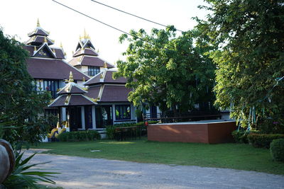 Exterior of building by trees against sky