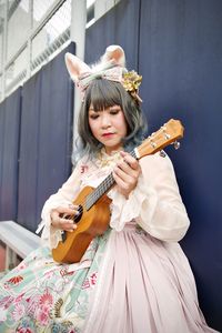 Portrait of happy girl playing at music concert