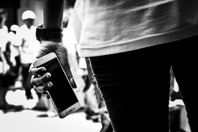 Reflection of man photographing on mobile phone