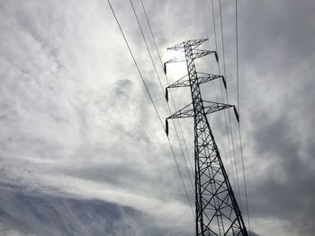 Low angle view of electricity pylon against sky