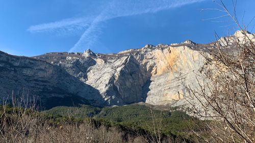 Scenic view of mountains against blue sky