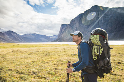 Full length of man standing on mountain against sky