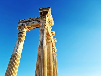 Low angle view of eiffel tower against clear blue sky