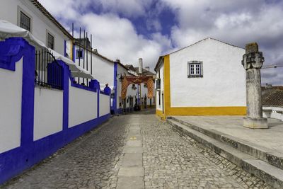 Street amidst buildings against sky